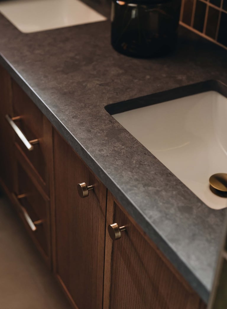a bathroom sink with a black counter top