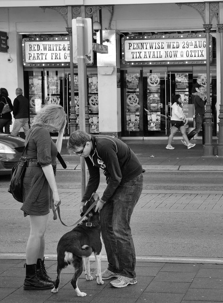 The lens of photographer Peter Pickering captures a couple with their dog in a Fremantle street