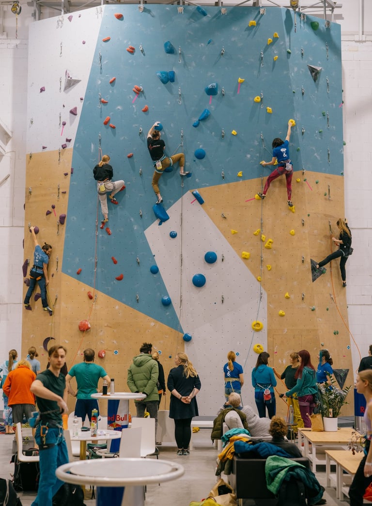 a group of people lead climbing