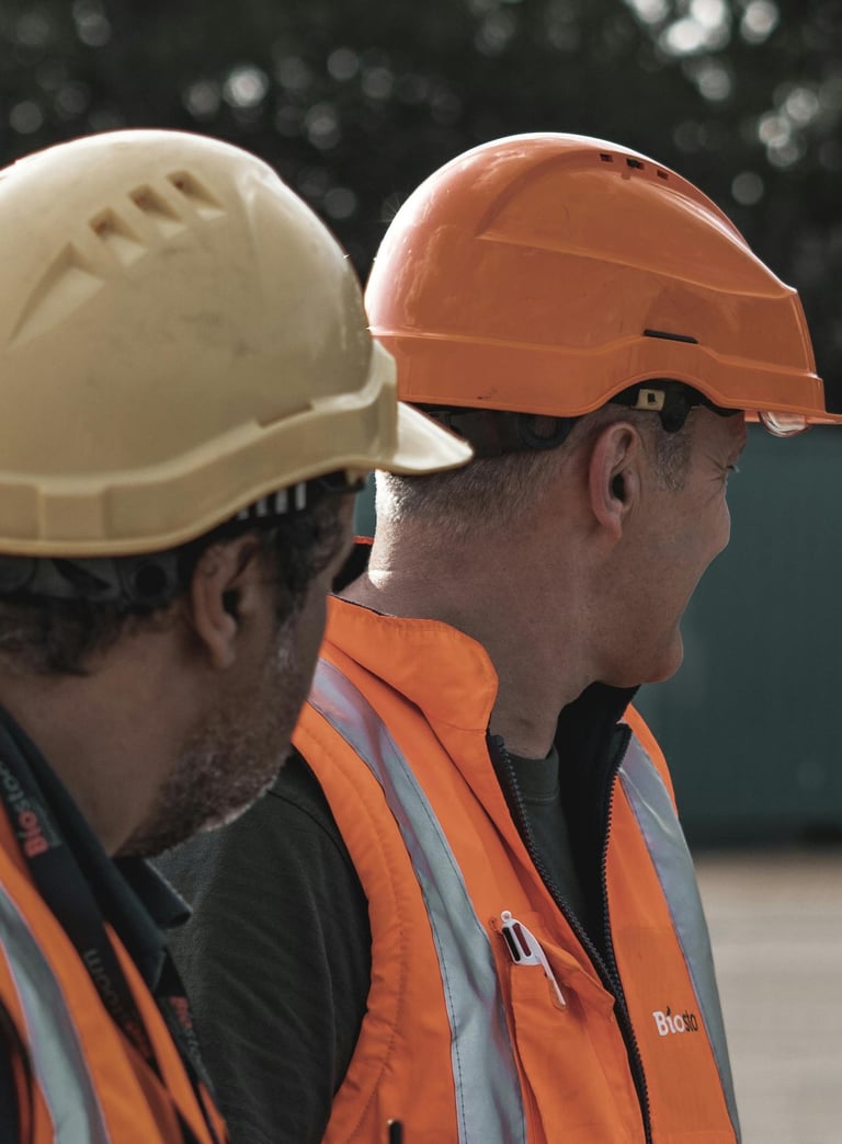two men in orange safety vests and safety vests