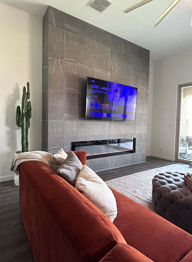 Mounted TV above custom tile fireplace in modern North Peoria living room.