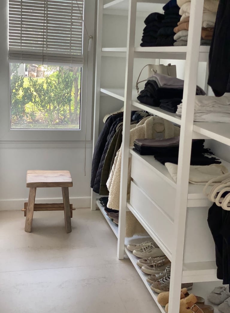 a closet with a bench and a bench in the corner
