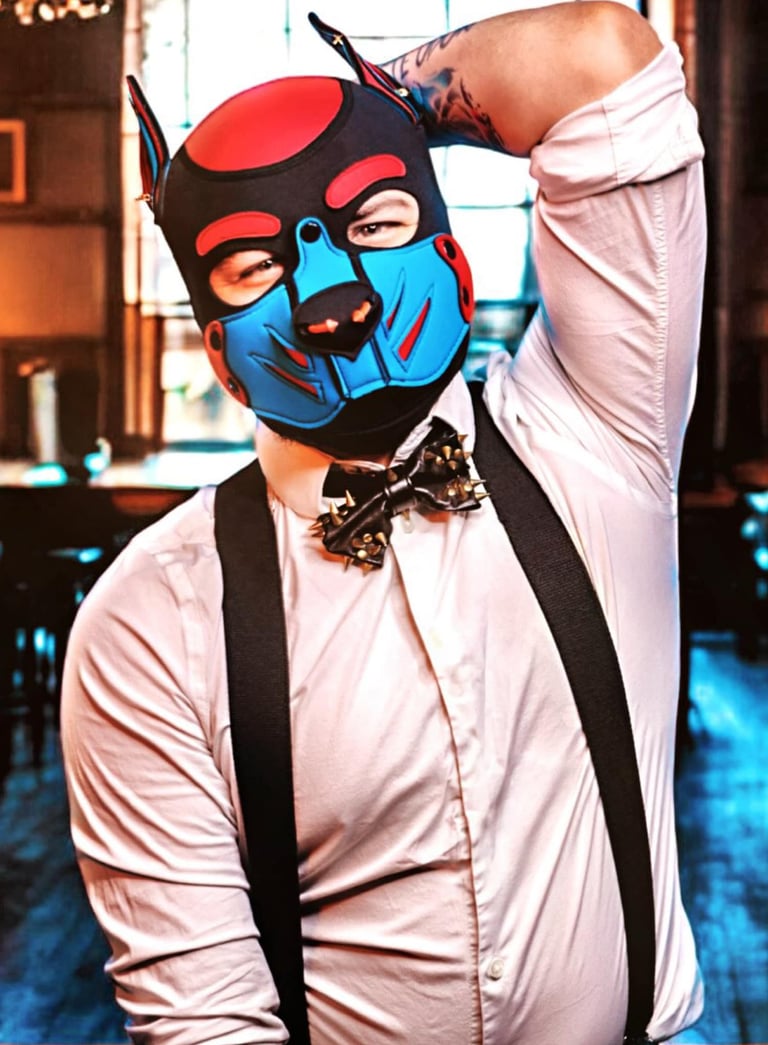 Man in a pup mask and bow tie.
