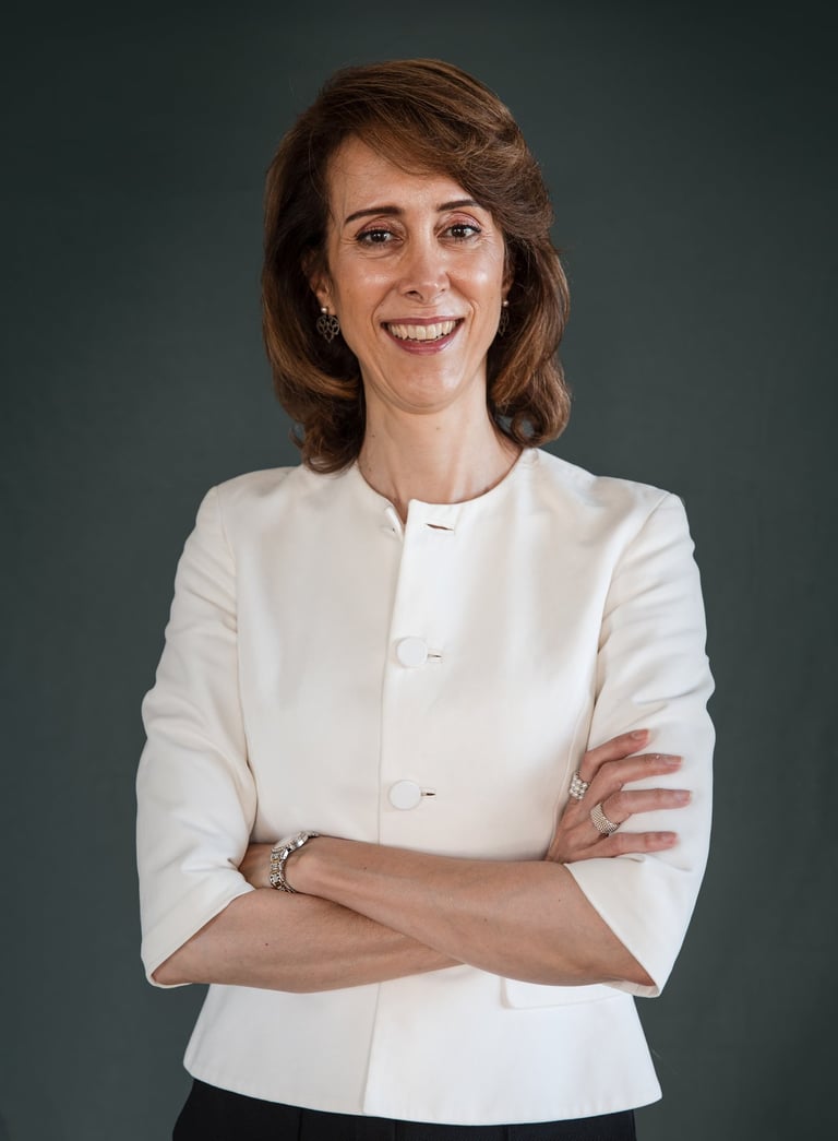 a female life coach in a white jacket and black pants
