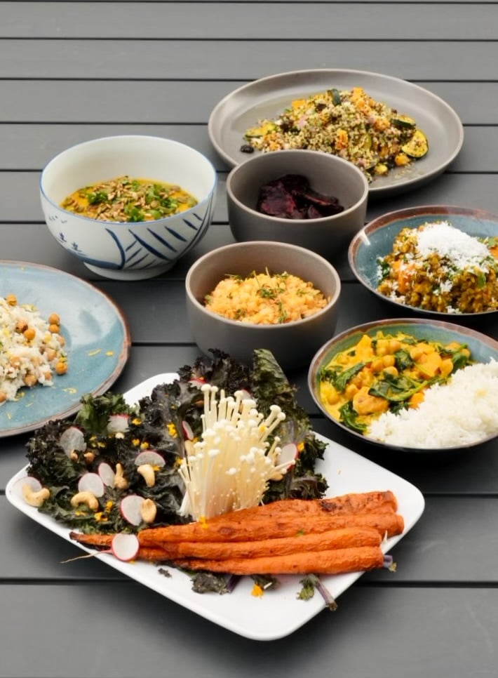 a table with bowls of vegetarian food 