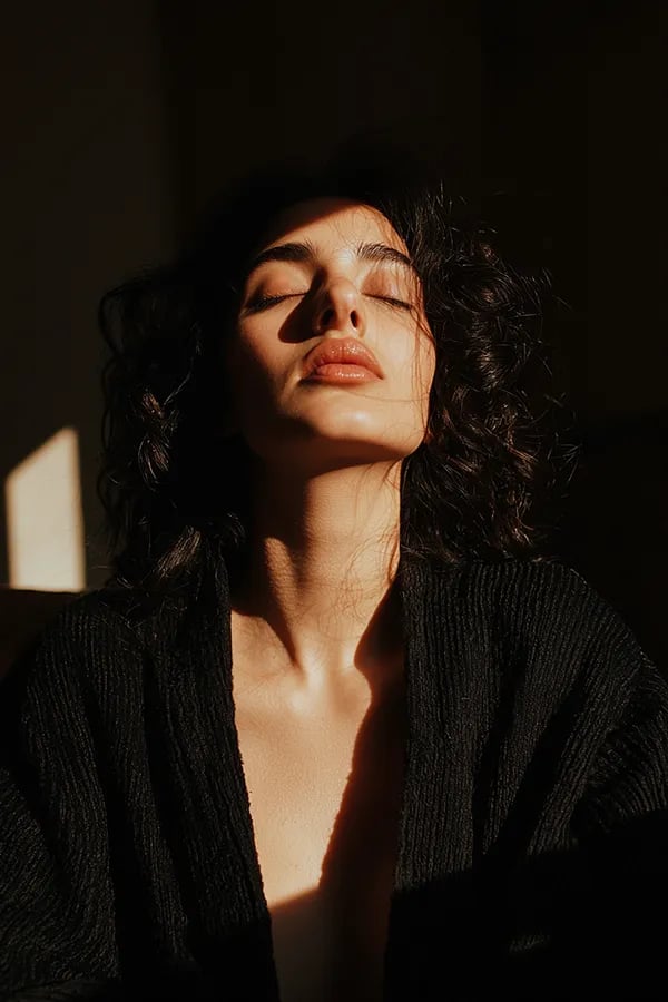 A WOMEN BATHED IN EARLY SUNLIGHT. A LUXURY IMAGE