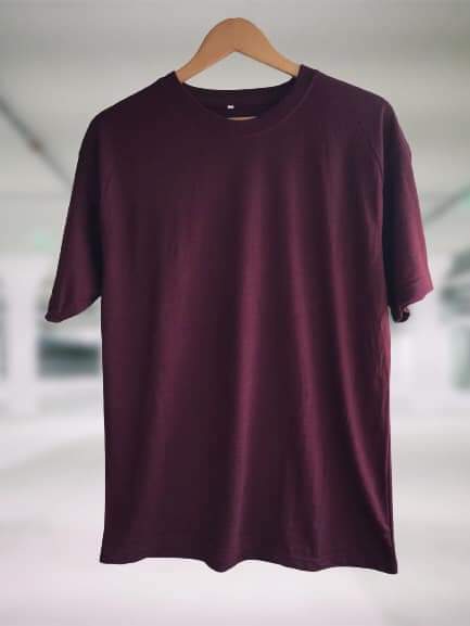 a plain maroon t-shirt displayed on a hanger