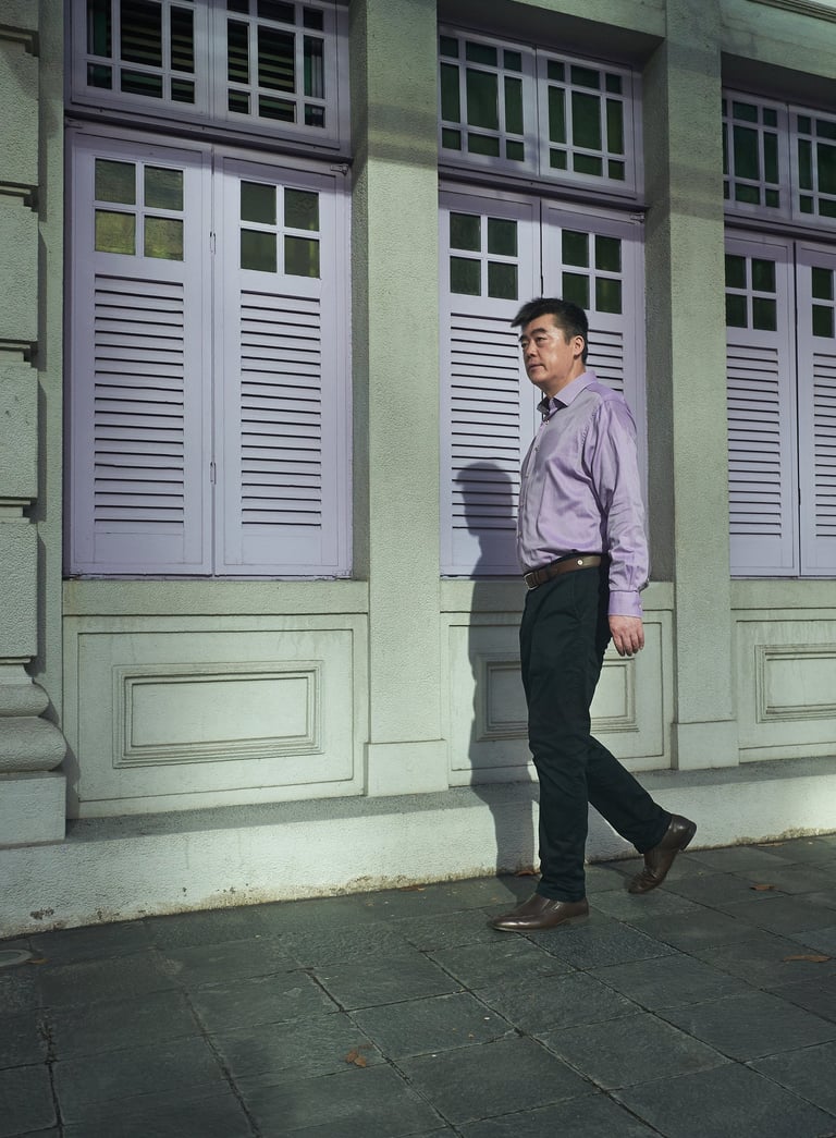 man in purple shirt walking on the street | olio my shop