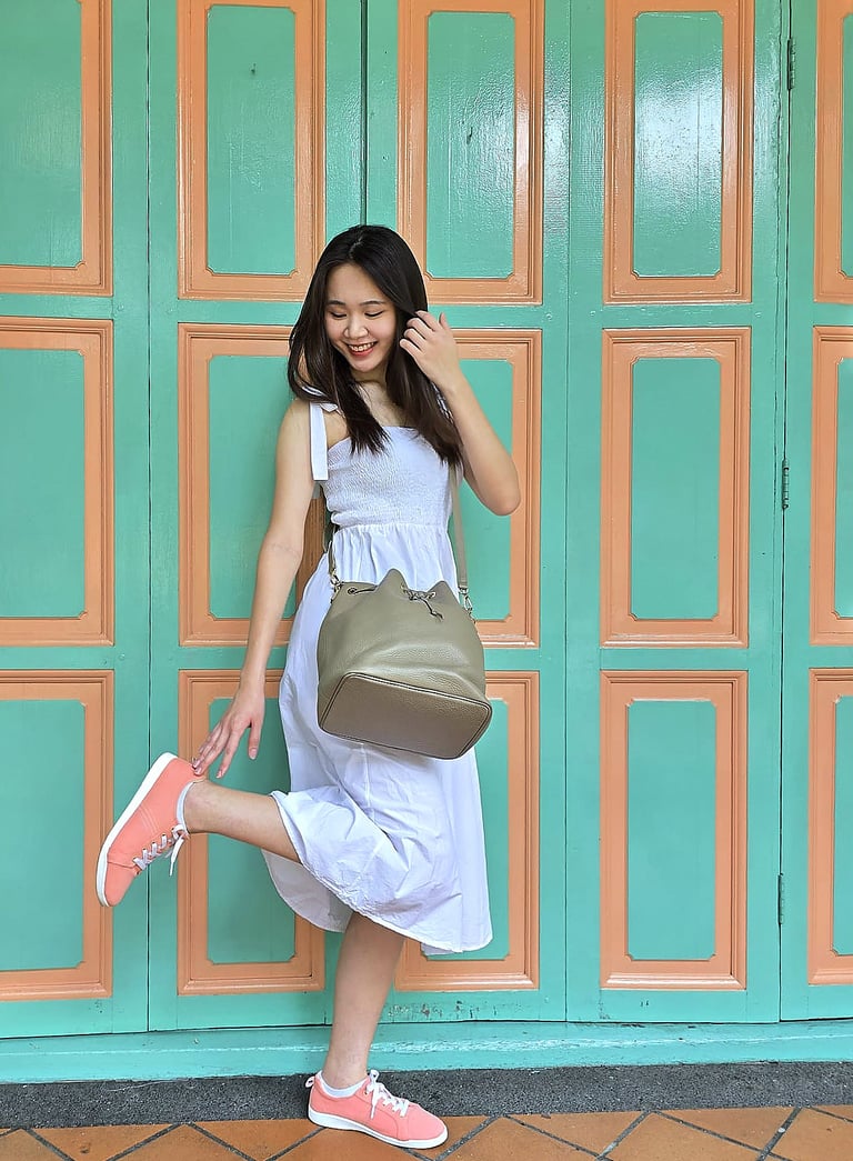 girl looking down at coral canvas shoes | olio my shop