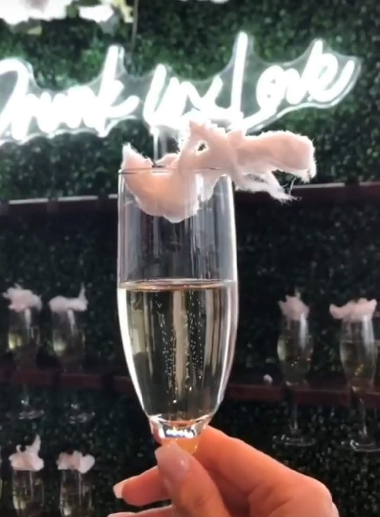 Drunk in love neon sign with a grass champagne wall rental for a baby shower