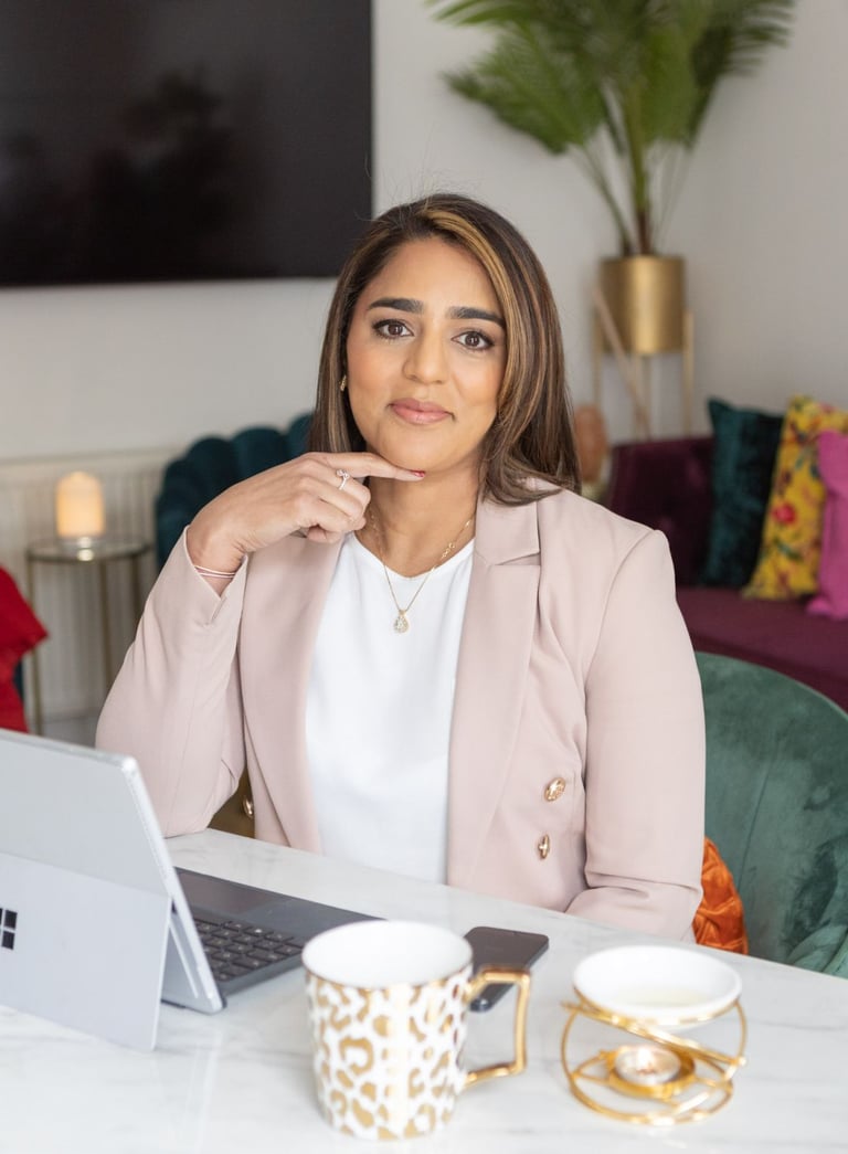 A photo of Anita sitting sat a desk