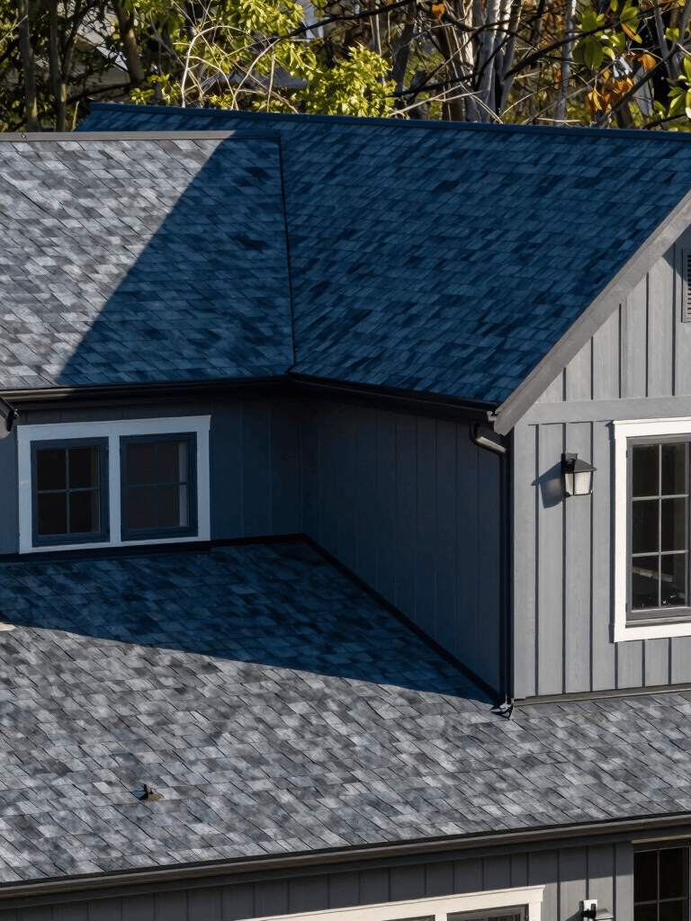 A modern residential home in New Jersey with a sleek navy blue and charcoal asphalt shingle roof, clean professional photography, North American / US.