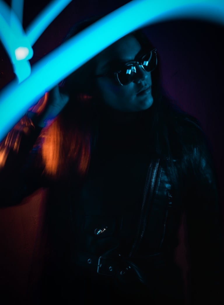 a woman in a leather jacket and sunglasses