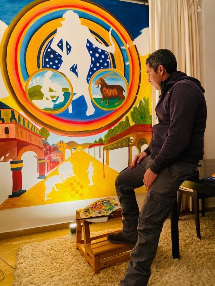 artist Yous contemplating his painting “Aquarius"