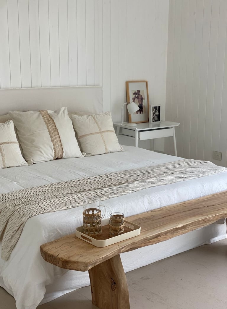 a bed with a wooden bench and a wooden bench with a wooden bench and a