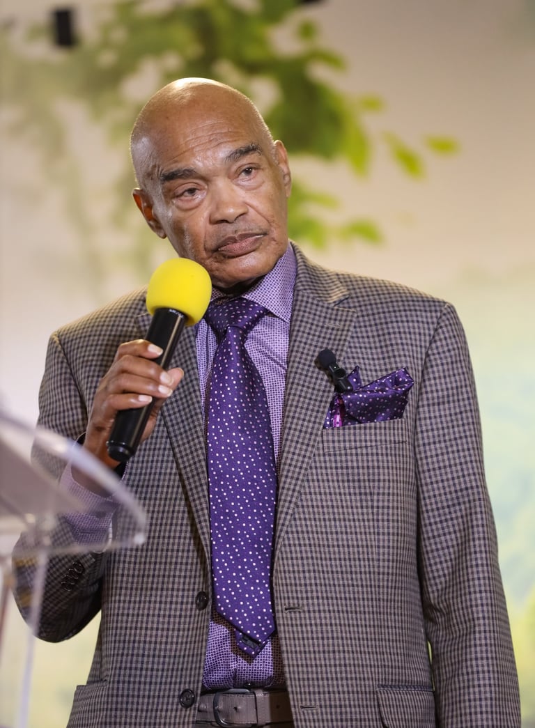 a man in a suit and tie is holding a microphone