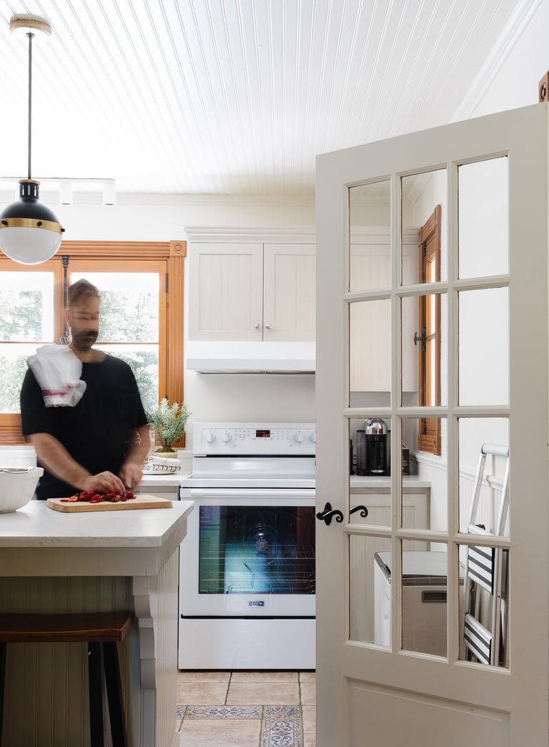 a man standing in a kitchen cooking