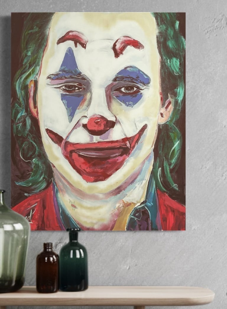 a painting of a joker's face with a painting of a clown