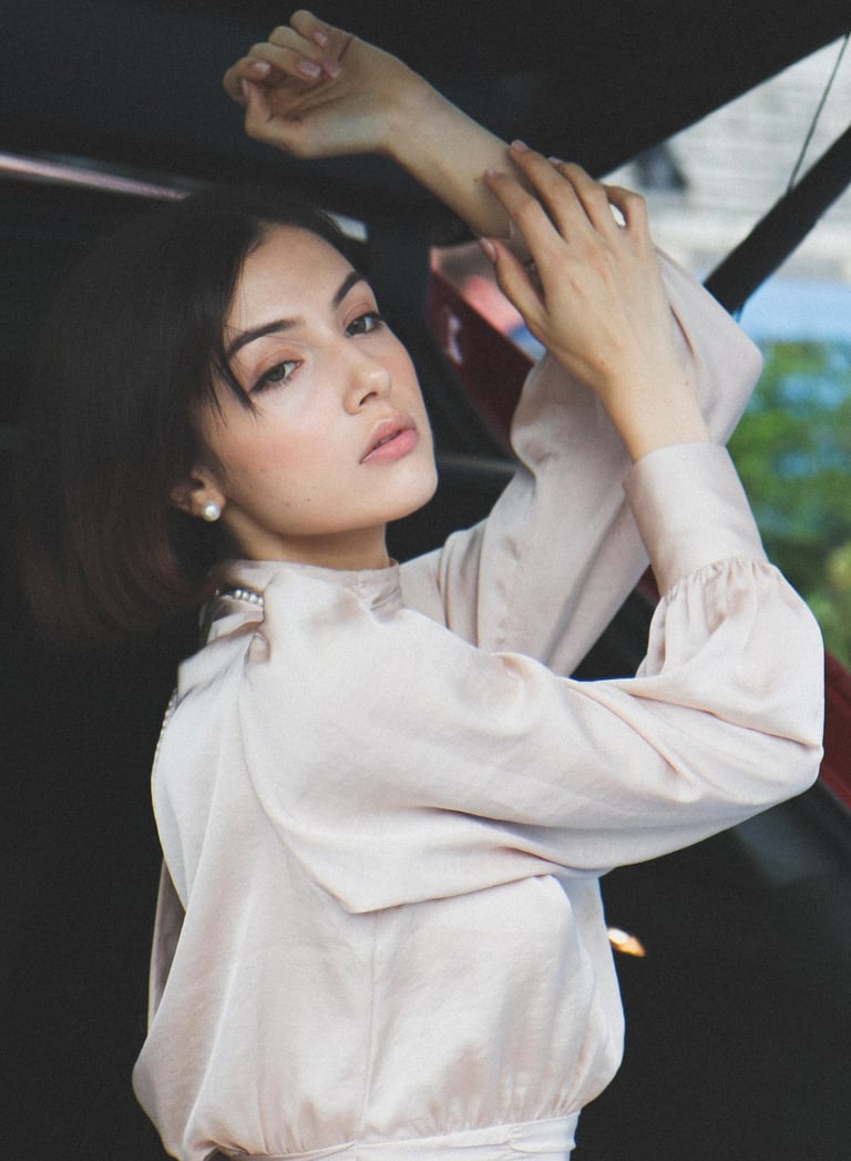 Creative portrait of a woman posing inside a car