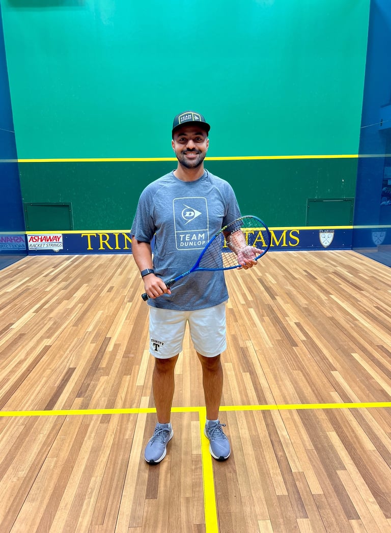a man in a blue shirt and white shorts holding a tennis racket