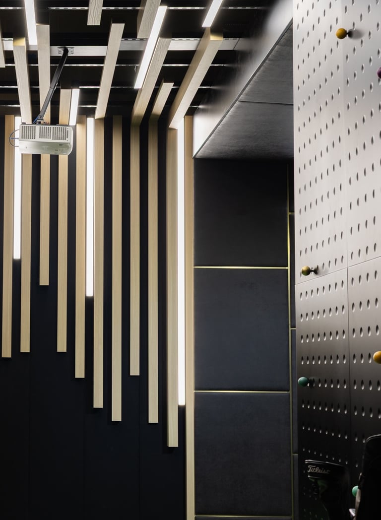 A bespoke, high-tech indoor golf simulator bay with a premium finish