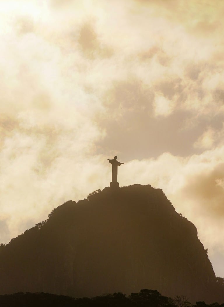 a statue of christ christ on a mountain top