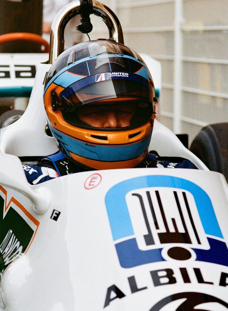 Zak Brown sat in a racing car with his helmet on before a race