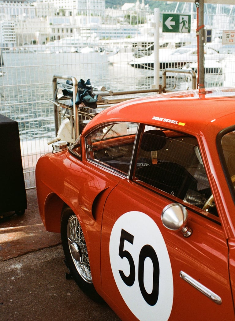 a red race car parked in the paddock