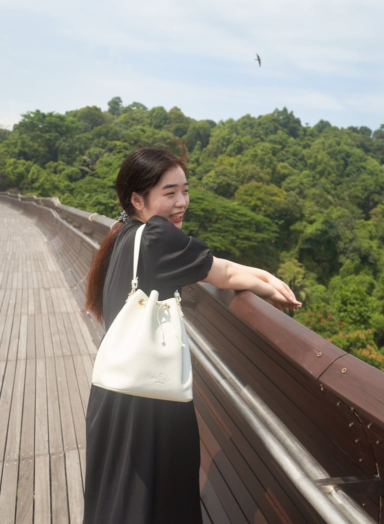 girl on a bridge with white bucket bag | olio my shop