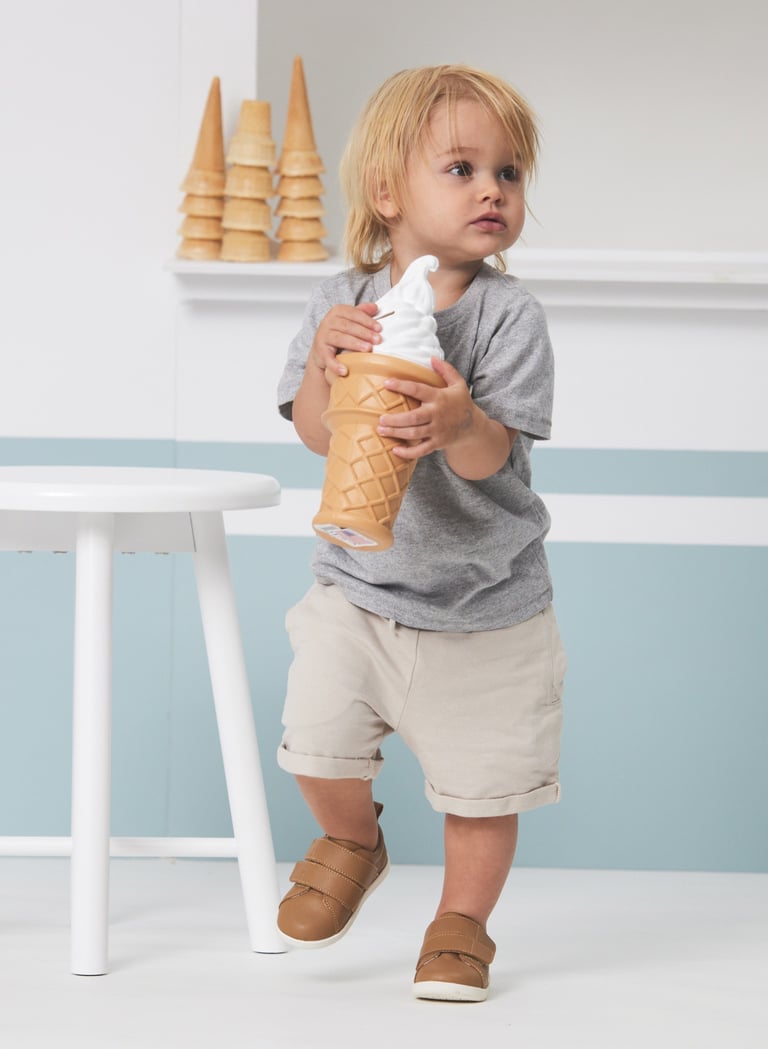 Fashion campaign photography - a toddler holding an ice cream in front of an ice cream shop