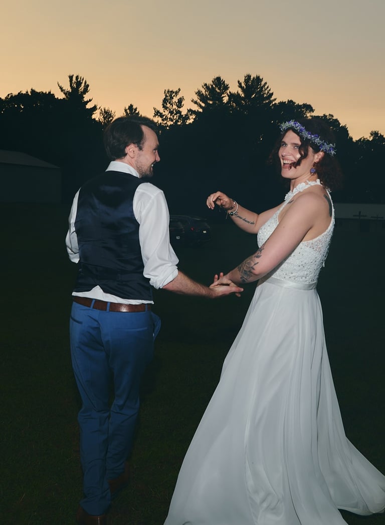 a bride and groom dancing at their wedding outdoor