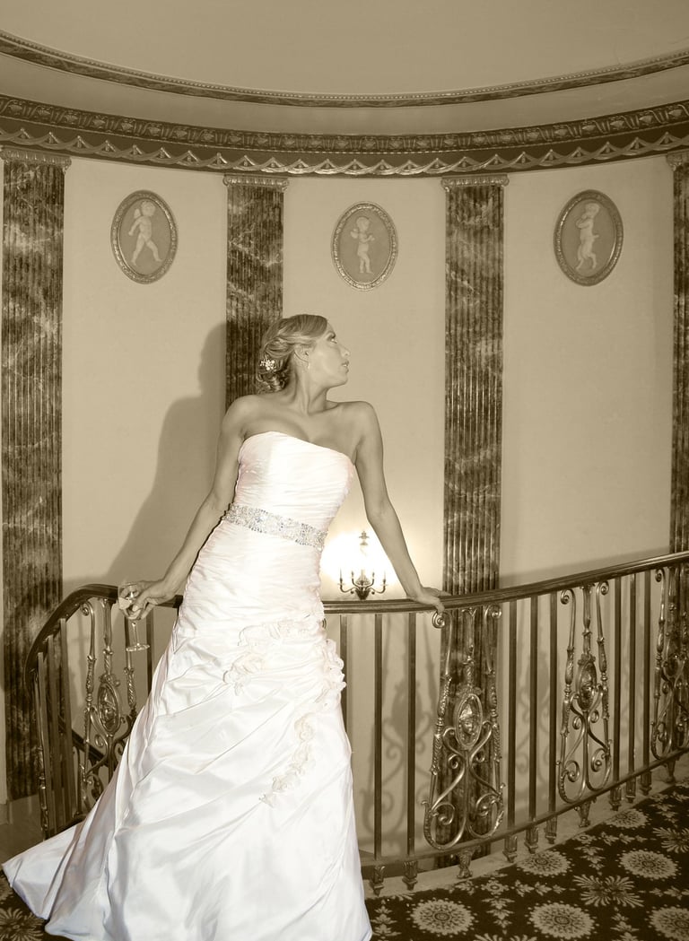 a bride in a strapless white dress posing in the hotel lobby