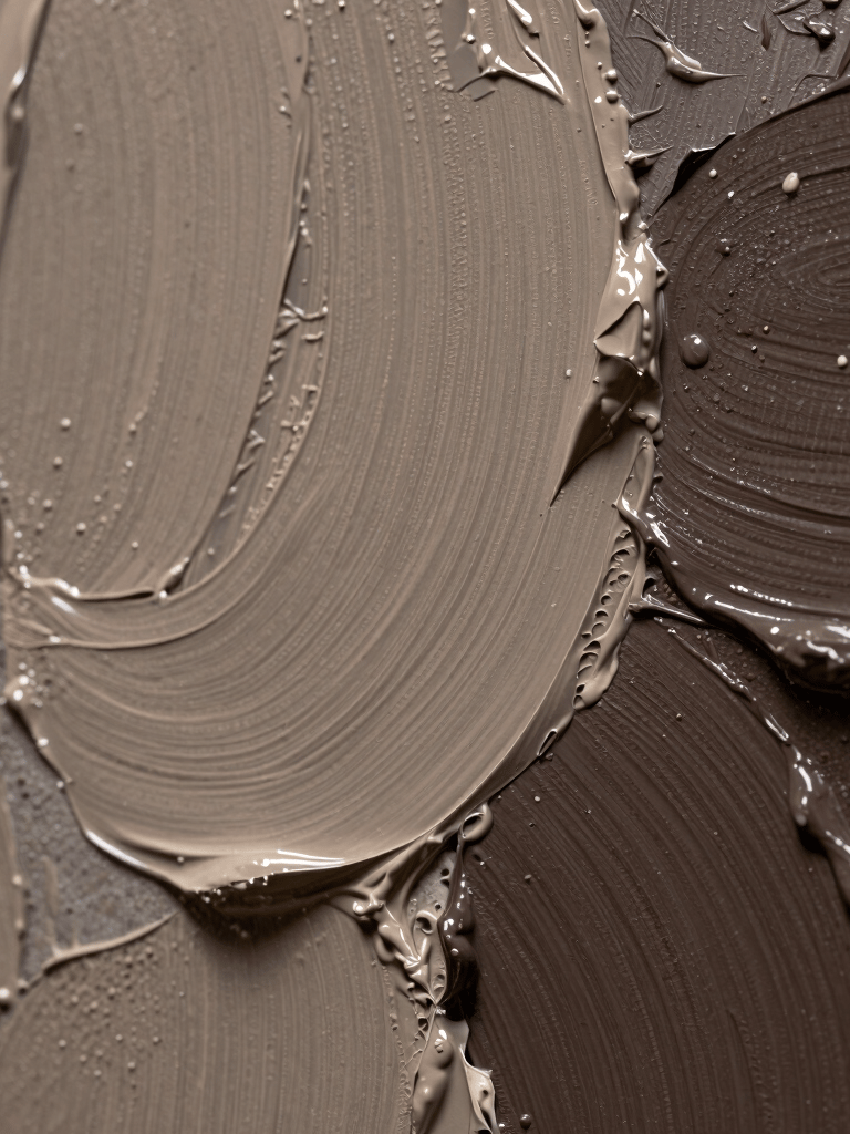 Macro photography of an artist's canvas showing thick, impasto brushstrokes of taupe and dark brown paint. The lighting emphasizes the texture and physical depth of the art. Sophisticated and professional aesthetic with a curated feel.