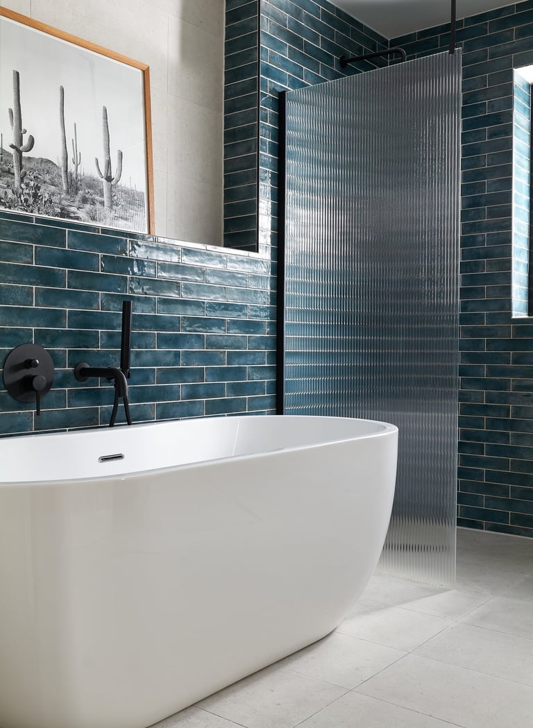 deep, glossy teal metro tiles, laid in a horizontal stack with white grout and fluted shower screen