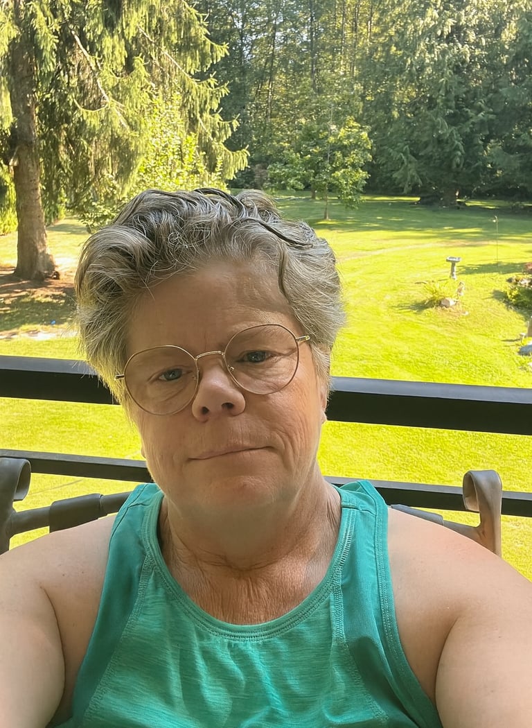 Author photo   Author and wellness coach Kerisma Vere smiling in front of green space