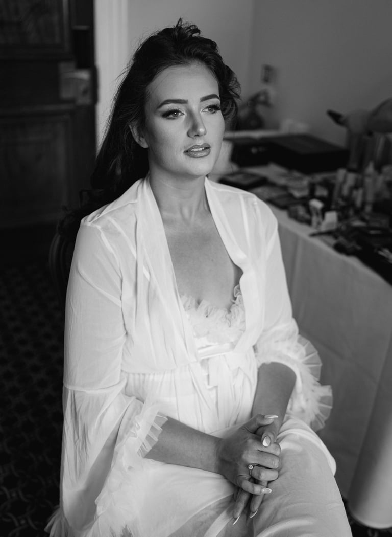 Bride wearing a robe and getting her makeup done at London Shenley Club