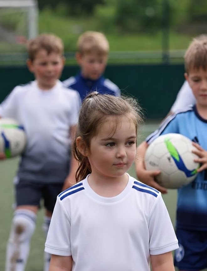 Girl with selective mutism is at a football club with other children.