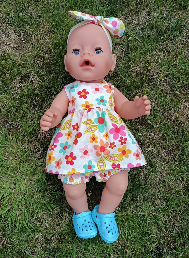 Baby Born doll in floral dress and spotted bloomers with matching hair bow
