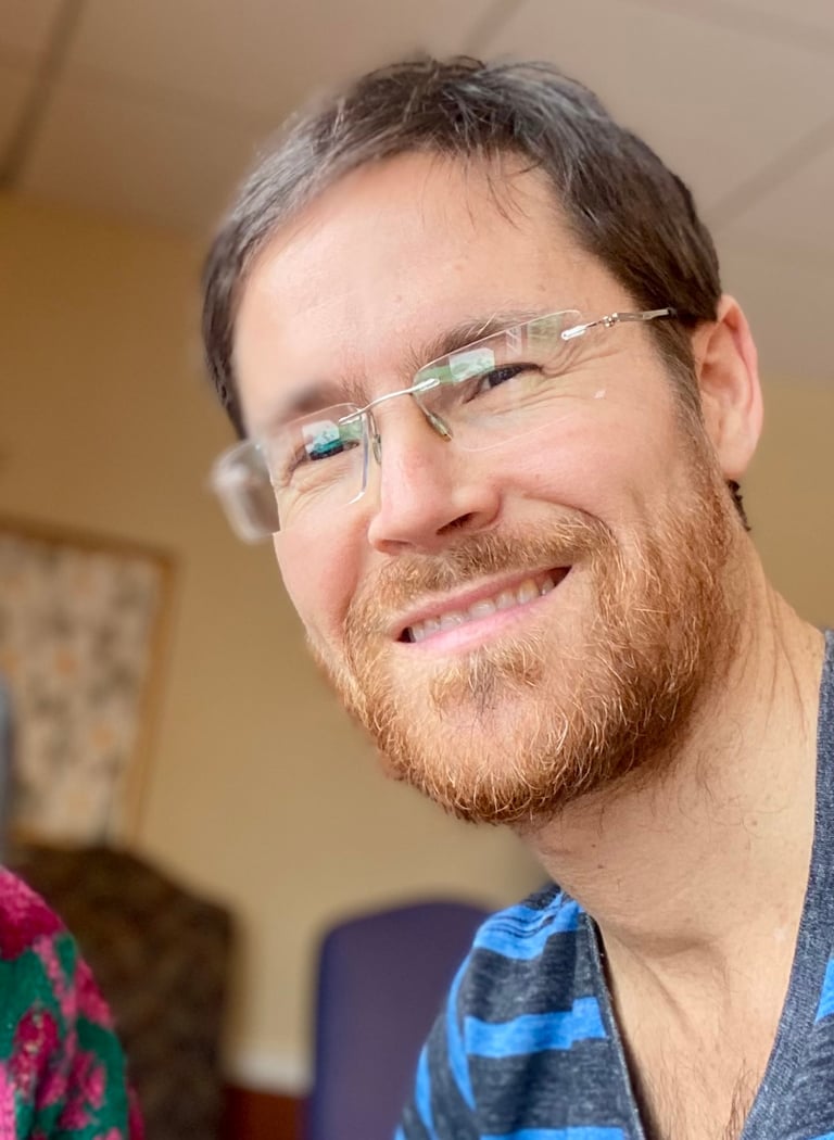 a man with glasses and a striped shirt