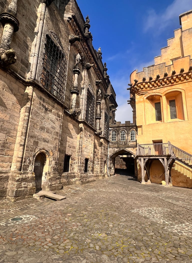 a stone building with a staircase going up the side of it