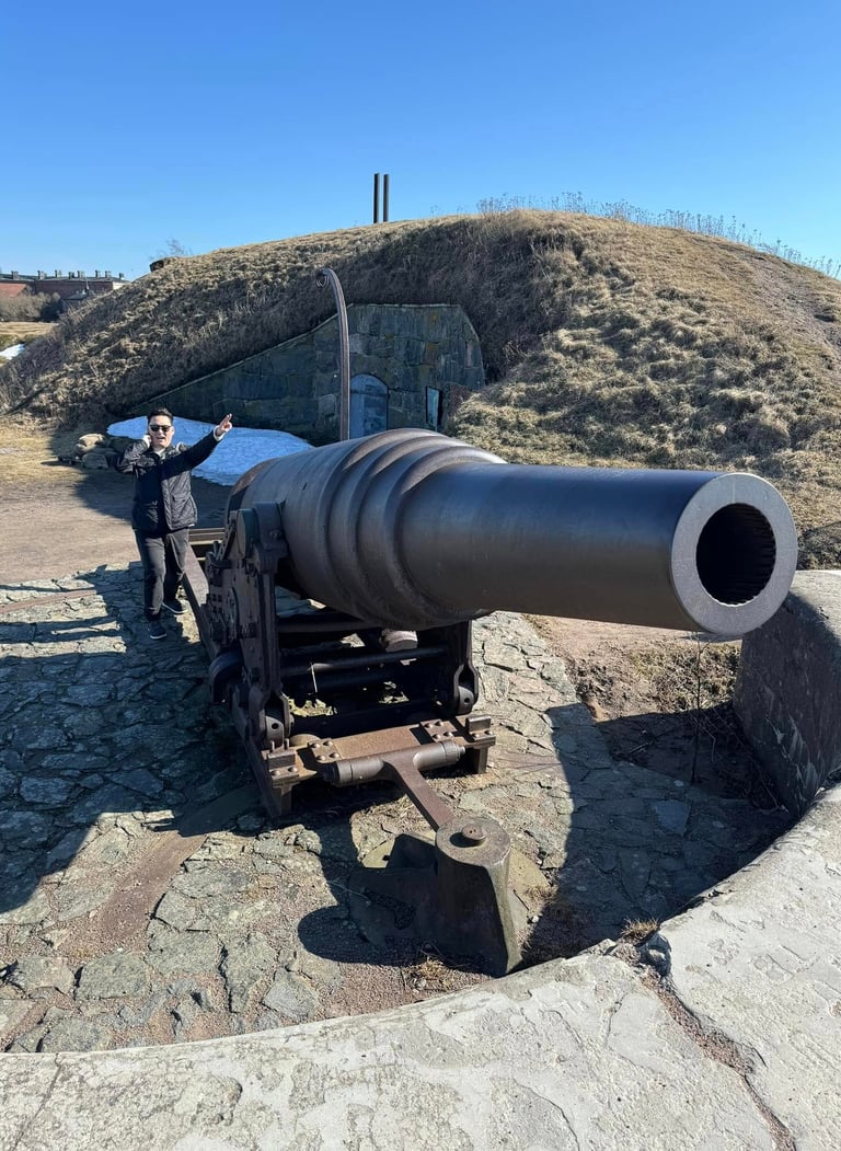 a man standing next to a large cannon