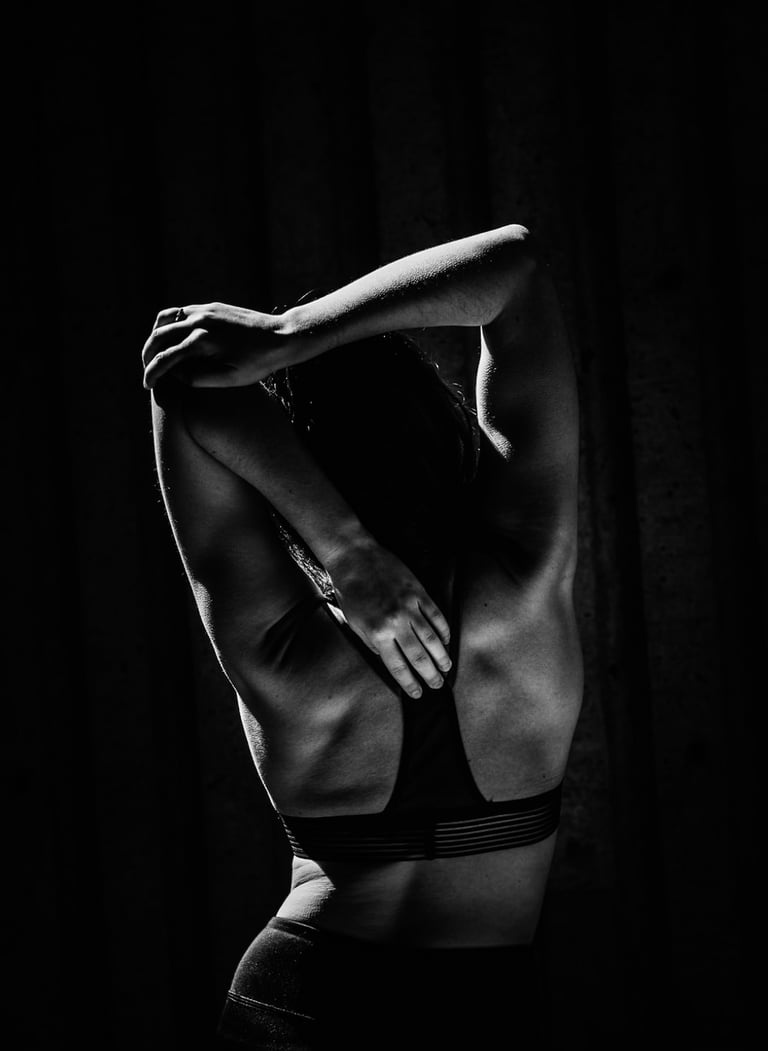 A woman stretches the muscles in the shoulders during yoga practice.