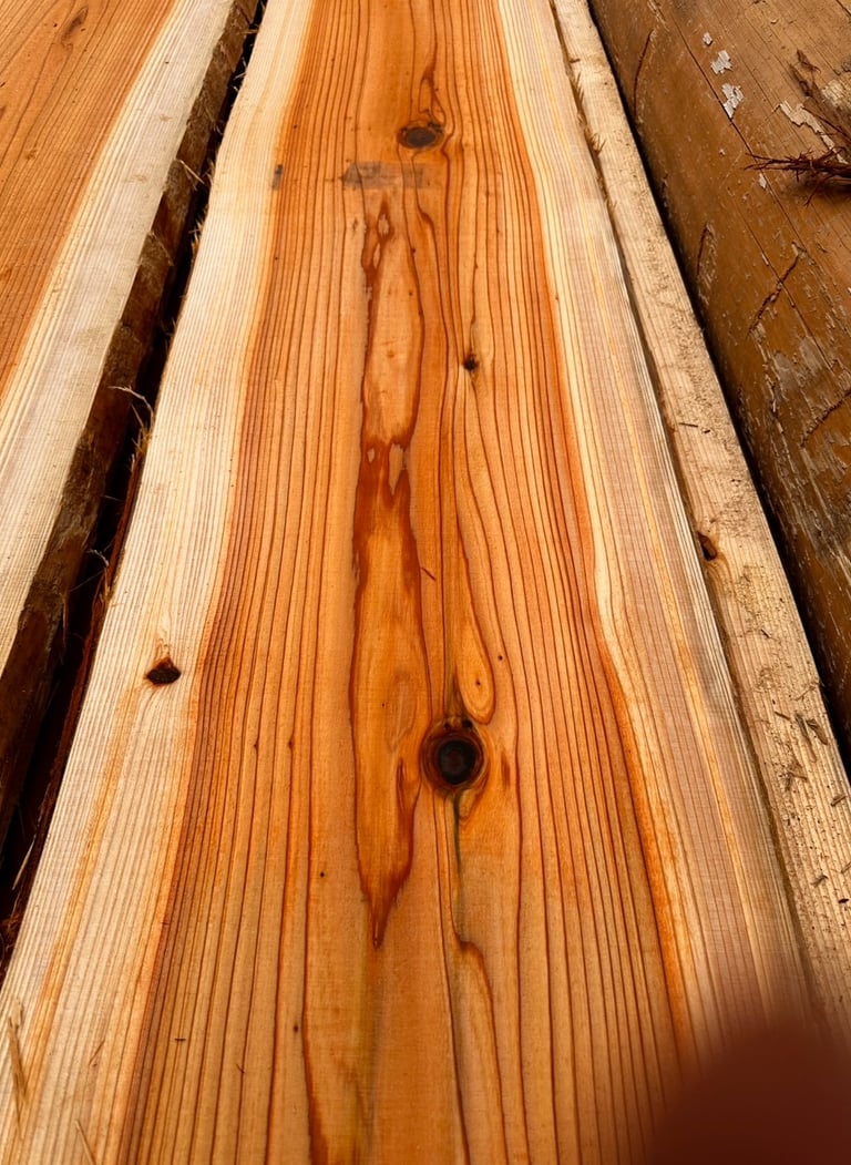 Close-up of natural sugi wood slabs showcasing detailed grain patterns and knots for woodworking.