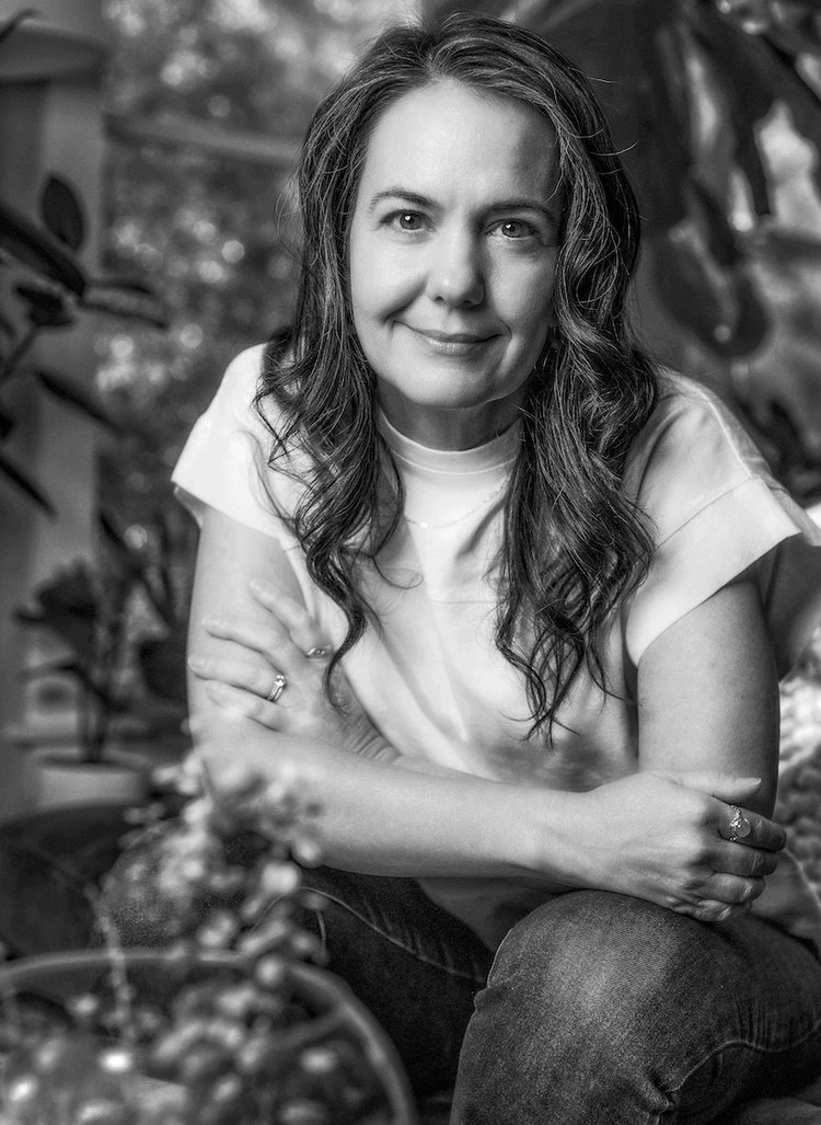 a woman sitting on a chair in a garden