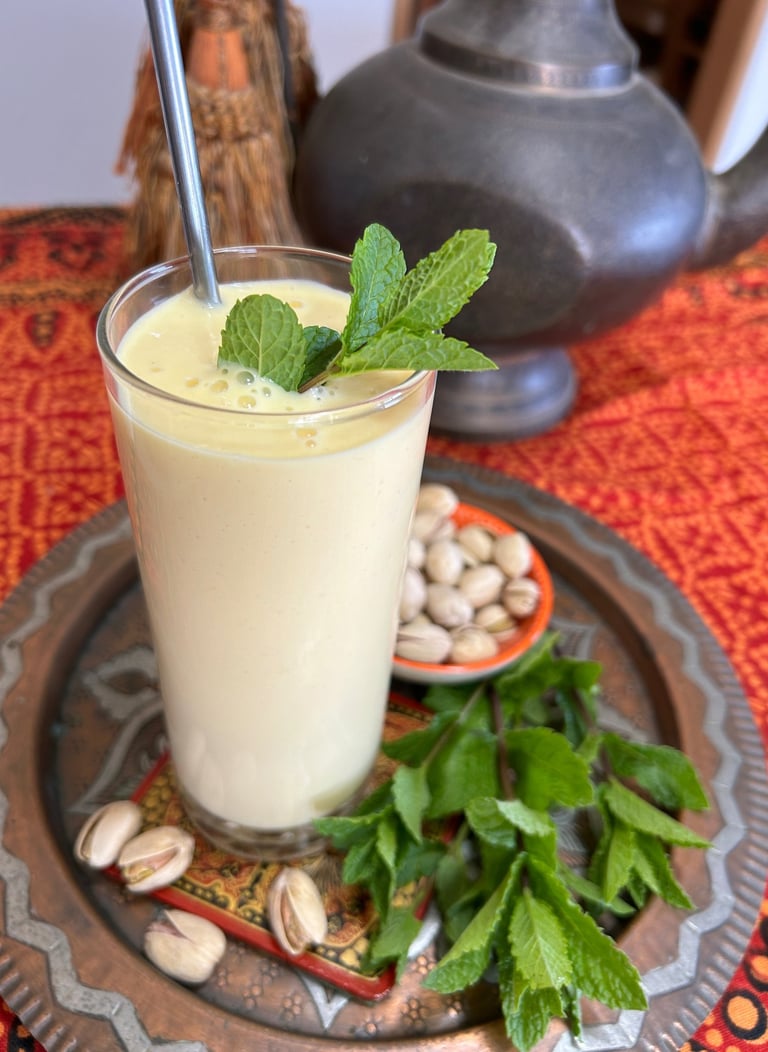 mango lass with nuts and mint leaves on copper plate