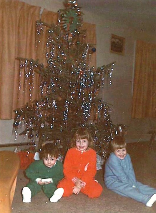 Derek, Karen and me in our "Sleepers". I am guessing 1974 or '75. Christmas morning by the tree.