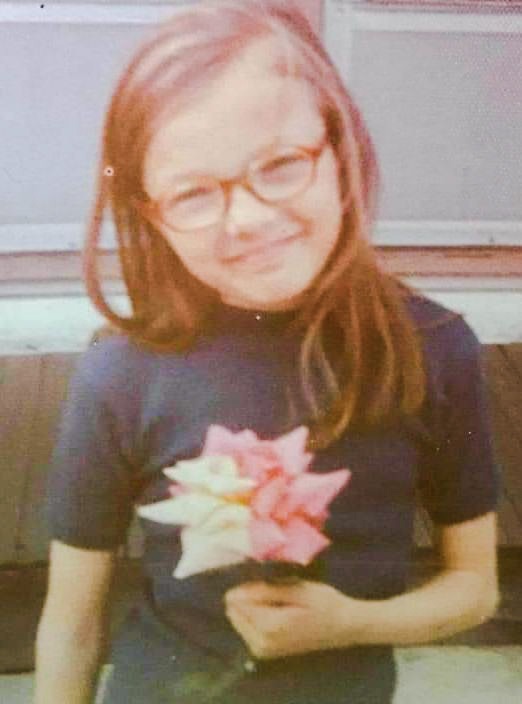Mary Bielecki with glasses and a flower in her hand