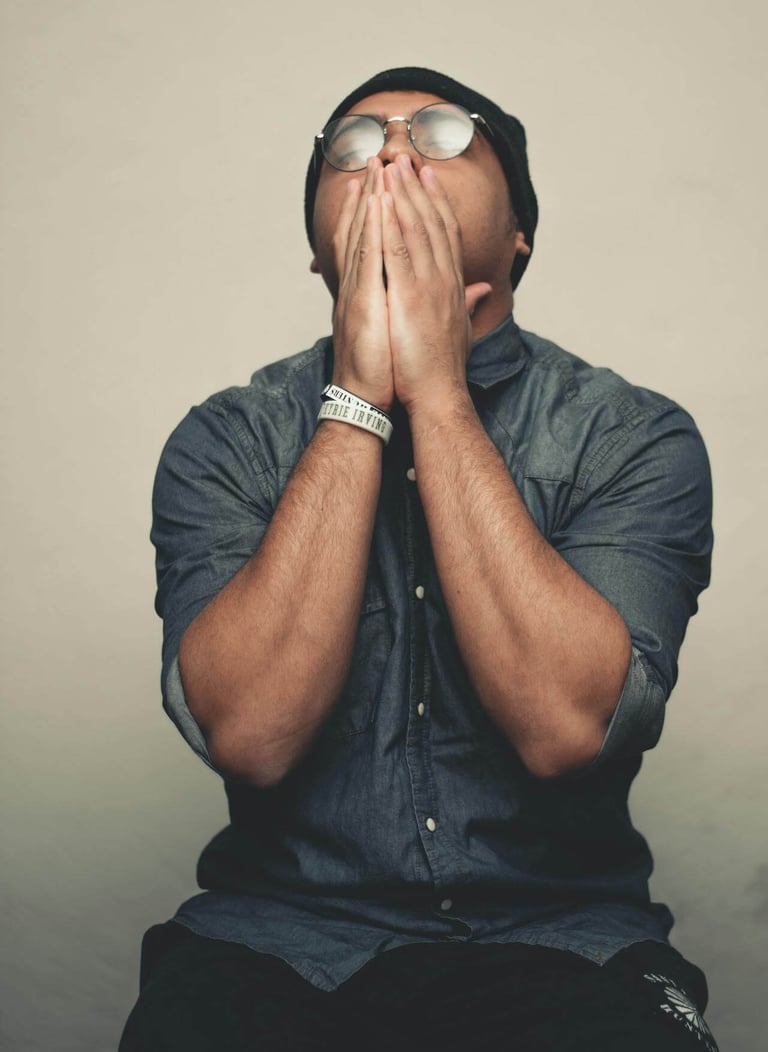 a man with sunglasses and a hat on his face