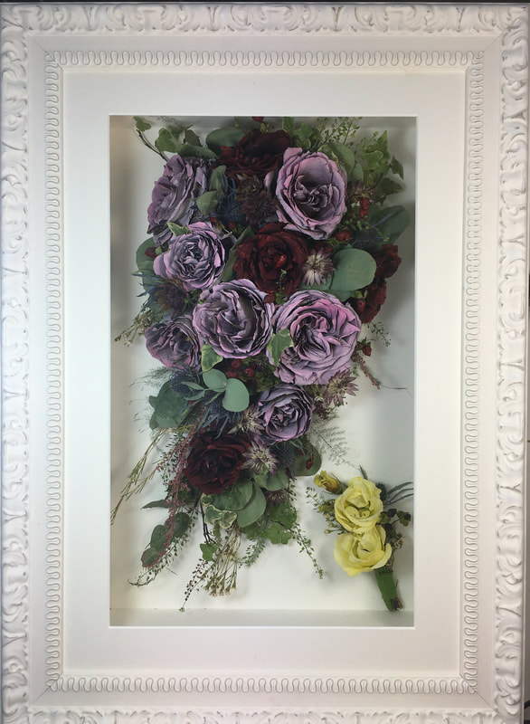 trailing view preserved wedding bouquet and buttonhole in a frame