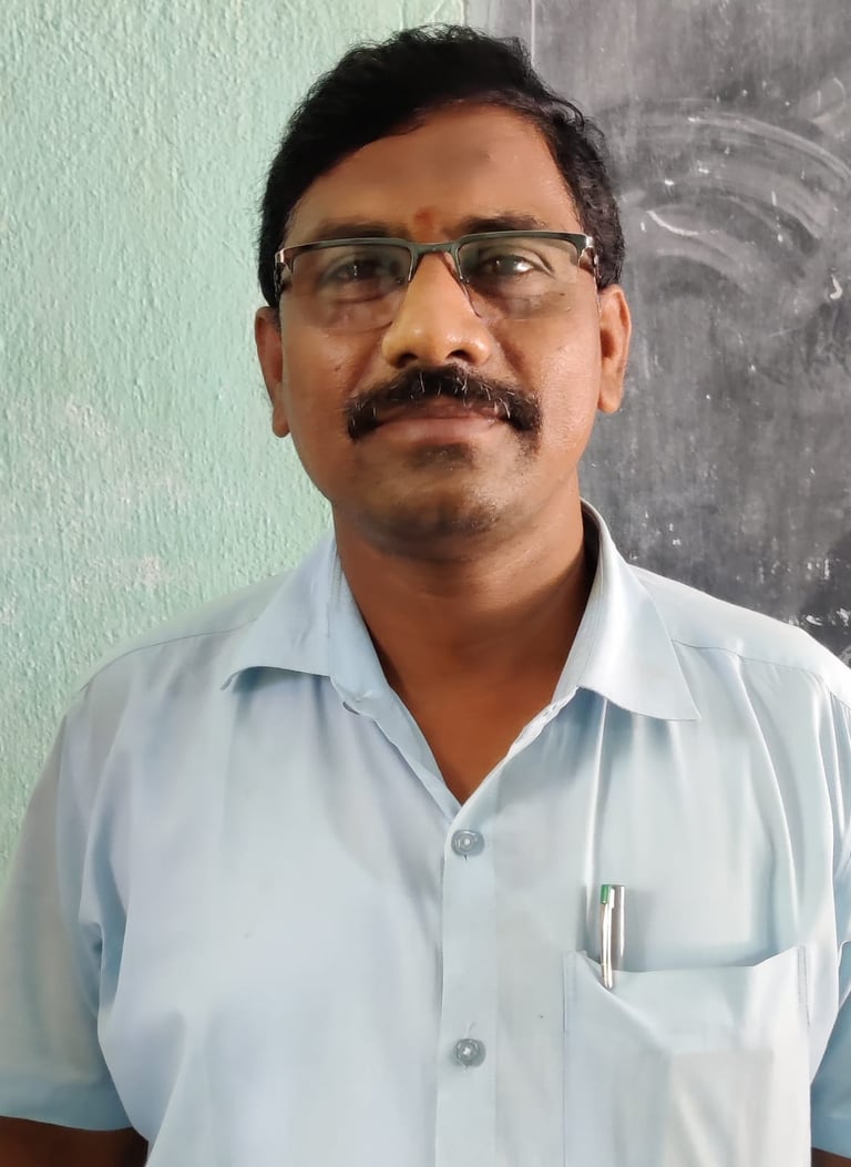 a man in a blue shirt and glasses
